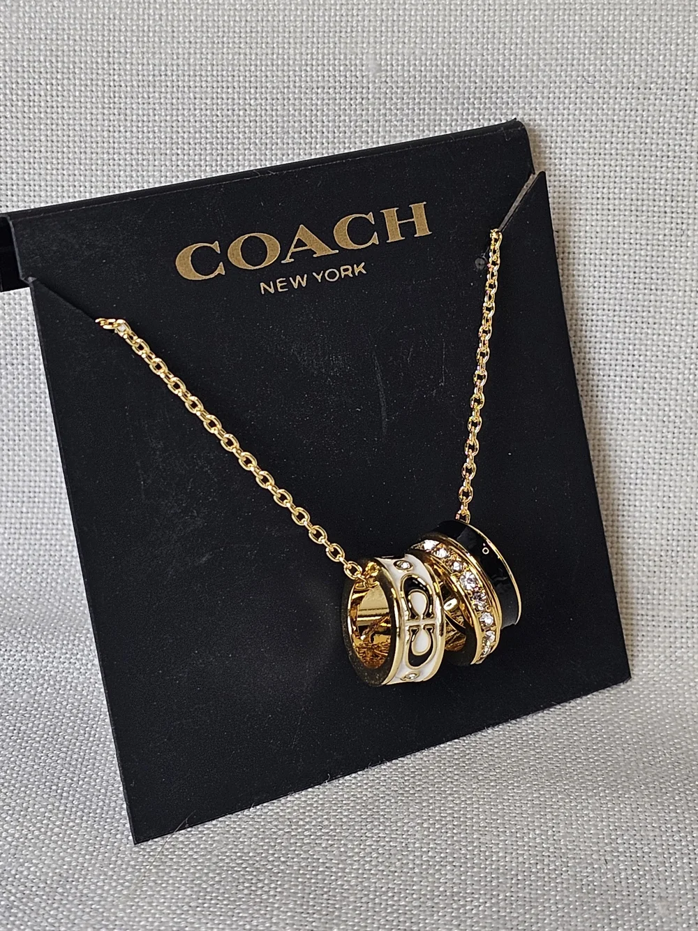 COACH Gold and Black Pendant Necklace with Crystal Accents